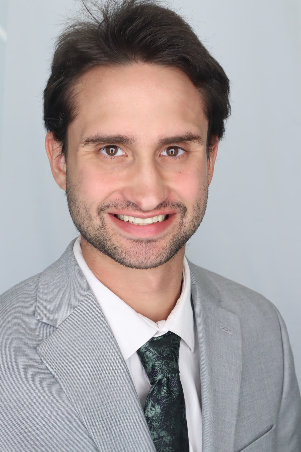 Samuel P. Lawton in a light gray suit and patterned dark green tie.